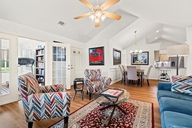 908 Bridges Dr, Arlington, TX 76012 - living room with light wood finished floors, a chandelier, ceiling fan, and high vaulted ceiling