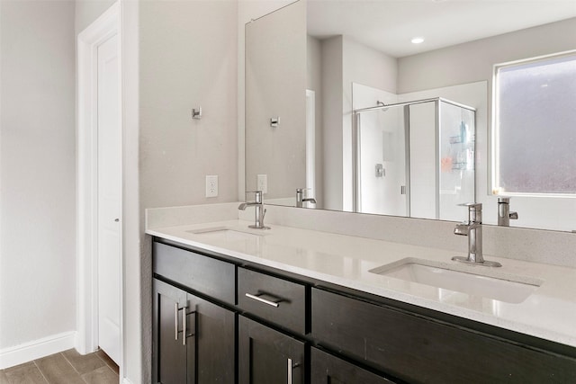 2013 Elara Dr, Haslet, TX 76052 - bathroom featuring a shower stall, double vanity, and baseboards