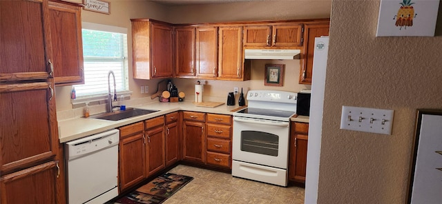 1708 N Bent Tree Trl, Grand Prairie, TX 75052 - kitchen with white appliances, under cabinet range hood, a sink, a textured wall, and light countertops