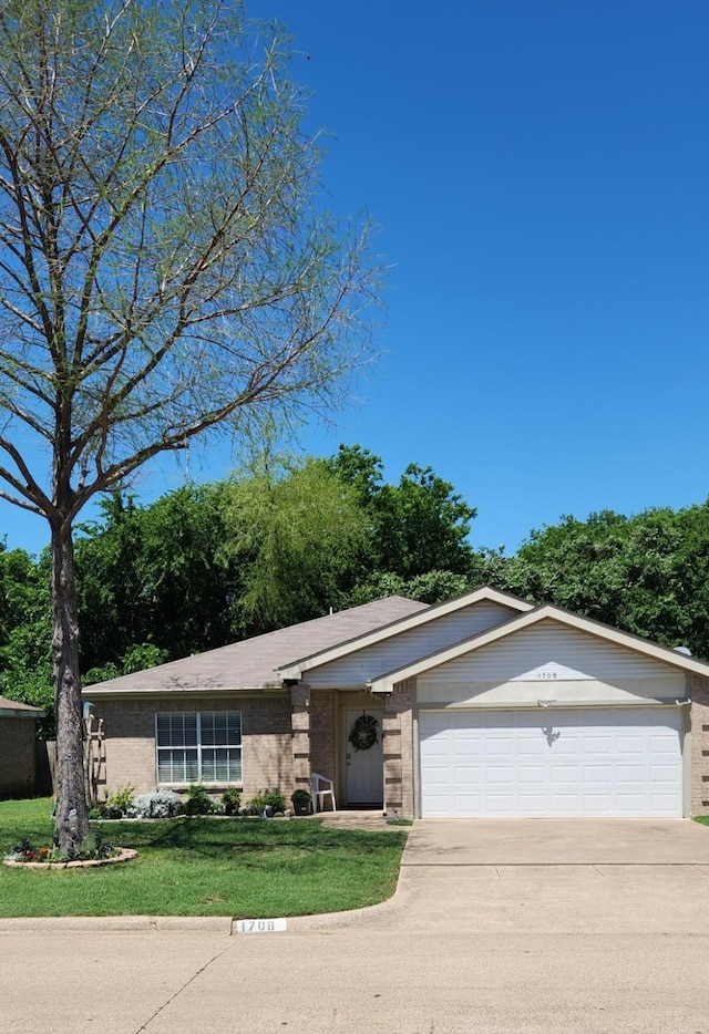 1708 N Bent Tree Trl, Grand Prairie, TX 75052 - view of front of house with a garage, concrete driveway, a front lawn, and brick siding