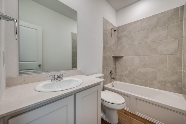 3209 Layla Creek Dr, Little Elm, TX 75068 - bathroom featuring toilet, wood finished floors, vanity, and washtub / shower combination