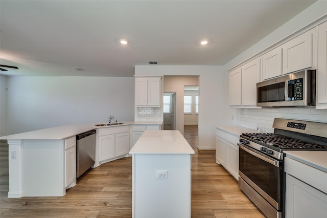 3209 Layla Creek Dr, Little Elm, TX 75068 - kitchen with stainless steel appliances, a peninsula, backsplash, light countertops, and recessed lighting