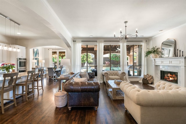 913 Bristlewood Dr, Mckinney, TX 75072 - living area featuring a chandelier, dark wood-type flooring, plenty of natural light, and ornamental molding