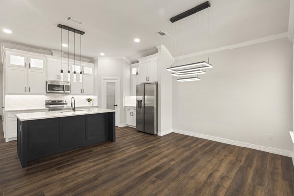 304 Pearl Harbor St, Tool, TX 75143 - kitchen featuring appliances with stainless steel finishes, light countertops, backsplash, dark wood finished floors, and white cabinetry