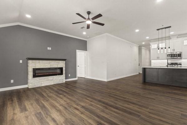 304 Pearl Harbor St, Tool, TX 75143 - unfurnished living room with recessed lighting, a ceiling fan, a fireplace, dark wood finished floors, and ornamental molding