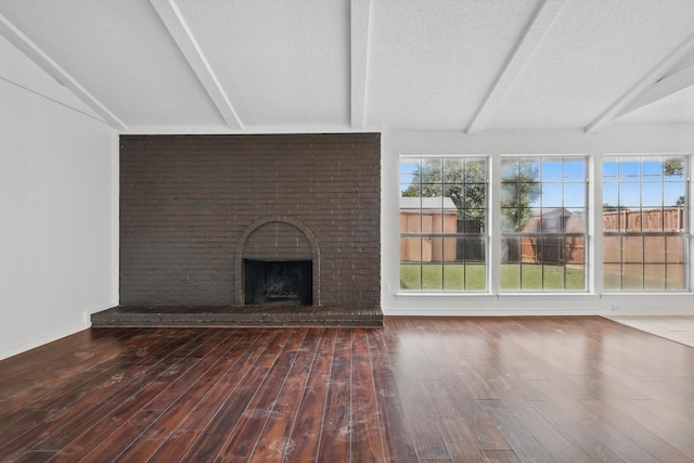 1713 Arvada Dr, Richardson, TX 75081 - unfurnished living room with wood finished floors, a fireplace, baseboards, and a textured ceiling