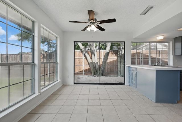 1713 Arvada Dr, Richardson, TX 75081 - empty room featuring a textured ceiling, ceiling fan, and light tile patterned flooring