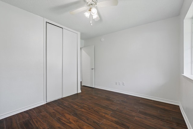 1713 Arvada Dr, Richardson, TX 75081 - unfurnished bedroom featuring a closet, dark wood-style flooring, baseboards, and a ceiling fan