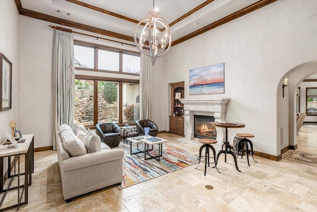 5909 Kittansett Ct, Fort Worth, TX 76132 - living room with a towering ceiling, baseboards, arched walkways, crown molding, and stone tile flooring