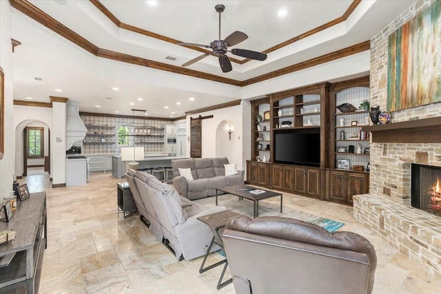 5909 Kittansett Ct, Fort Worth, TX 76132 - living area featuring ornamental molding, a ceiling fan, a fireplace, recessed lighting, and a raised ceiling