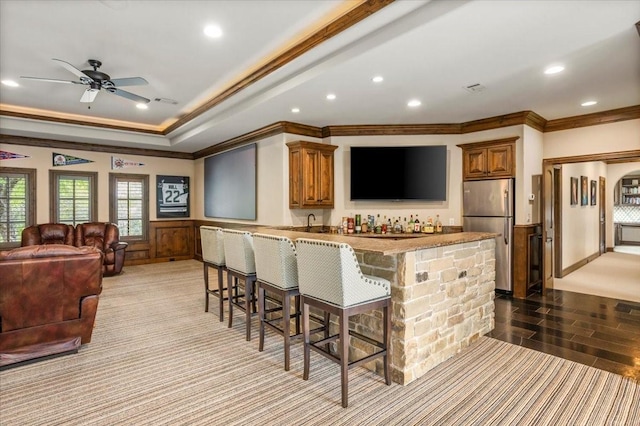 5909 Kittansett Ct, Fort Worth, TX 76132 - kitchen with freestanding refrigerator, crown molding, a peninsula, a breakfast bar, and recessed lighting