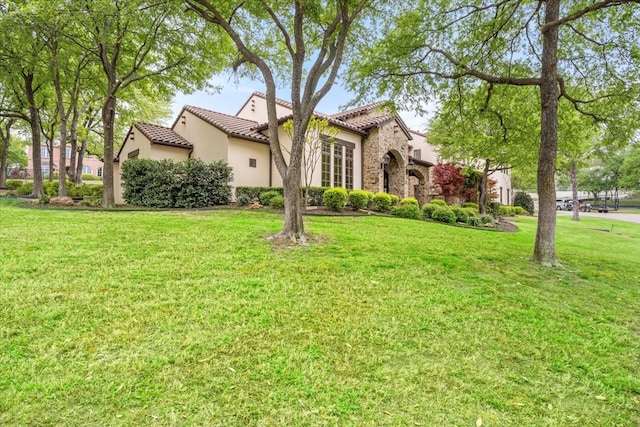 5909 Kittansett Ct, Fort Worth, TX 76132 - mediterranean / spanish house featuring stucco siding, a tile roof, a front lawn, and stone siding