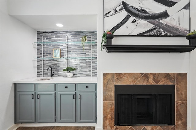 645 Spring Valley Rd, Allen, TX 75002 - detailed view of a sink, a tile fireplace, backsplash, and recessed lighting