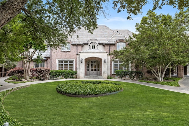 8722 Arbor Park Ct, Dallas, TX 75243 - view of front of home featuring a high end roof, brick siding, and a front lawn
