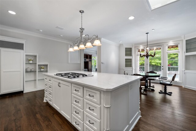 8722 Arbor Park Ct, Dallas, TX 75243 - kitchen with a chandelier, stainless steel gas cooktop, a center island, ornamental molding, and dark wood-type flooring