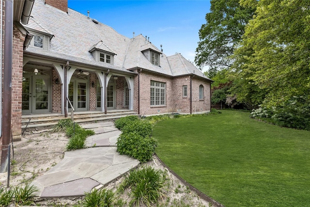 8722 Arbor Park Ct, Dallas, TX 75243 - exterior space with a high end roof, a lawn, brick siding, a chimney, and a ceiling fan