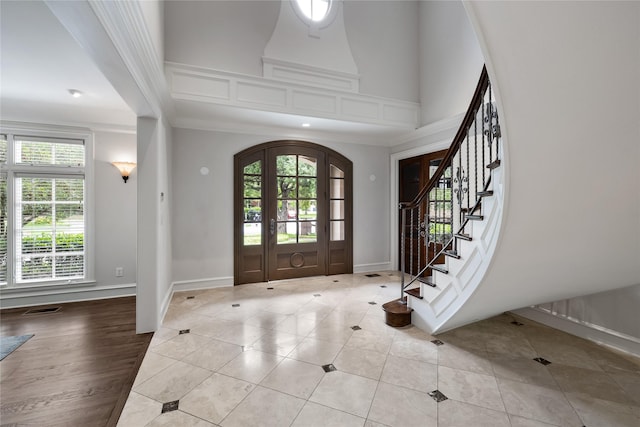 8722 Arbor Park Ct, Dallas, TX 75243 - entryway with baseboards, stairs, crown molding, light tile patterned floors, and arched walkways