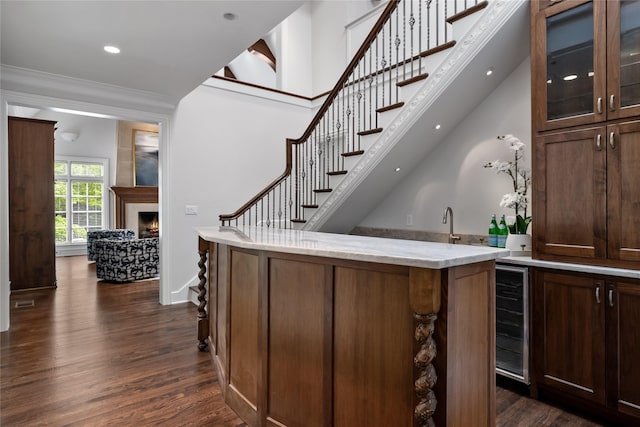 8722 Arbor Park Ct, Dallas, TX 75243 - bar featuring beverage cooler, dark wood finished floors, a lit fireplace, stairway, and recessed lighting