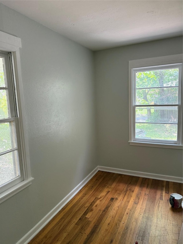 1405 S Hatcher St, Decatur, TX 76234 - unfurnished room featuring dark wood-type flooring, baseboards, and plenty of natural light