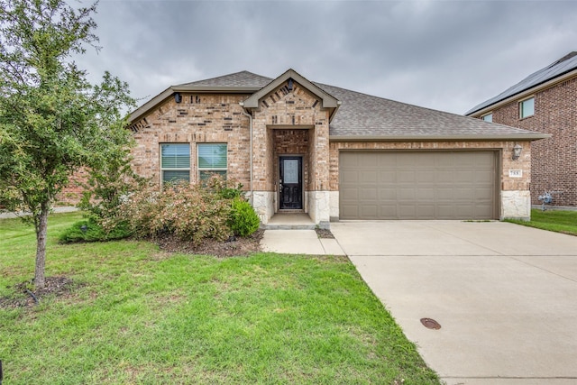 788 Cascade Ln, Princeton, TX 75407 - french country home with a shingled roof, concrete driveway, an attached garage, and a front lawn