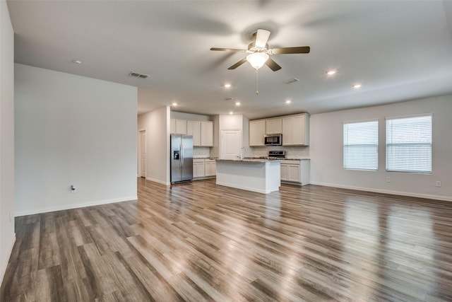 788 Cascade Ln, Princeton, TX 75407 - unfurnished living room featuring a ceiling fan, a sink, wood finished floors, baseboards, and recessed lighting