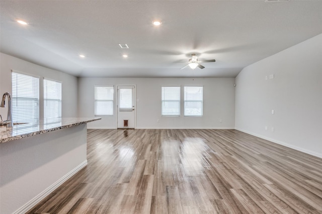 788 Cascade Ln, Princeton, TX 75407 - unfurnished living room with a sink, a ceiling fan, light wood-style flooring, baseboards, and recessed lighting