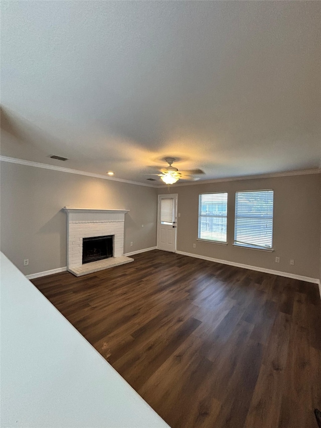 2005 Fairview Dr, Forney, TX 75126 - unfurnished living room with crown molding, a brick fireplace, dark wood-style flooring, a ceiling fan, and recessed lighting