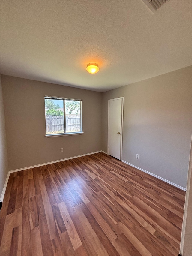 2005 Fairview Dr, Forney, TX 75126 - unfurnished room with wood finished floors and a textured ceiling