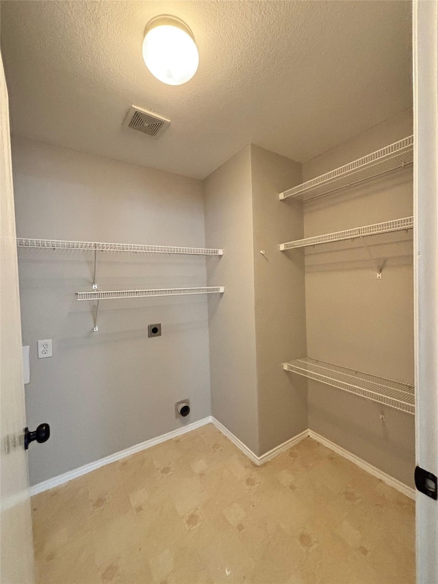 2005 Fairview Dr, Forney, TX 75126 - laundry room featuring hookup for an electric dryer, a textured ceiling, and tile patterned floors
