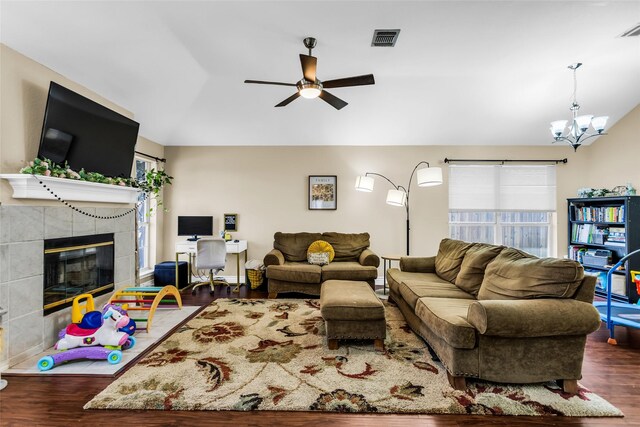 6923 Todd Ln, Sachse, TX 75048 - living room with vaulted ceiling, wood finished floors, ceiling fan, a tile fireplace, and a chandelier