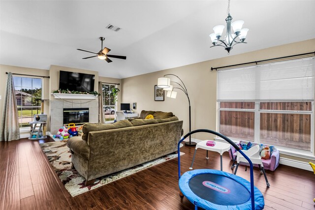 6923 Todd Ln, Sachse, TX 75048 - living room featuring a chandelier, a tile fireplace, wood finished floors, and ceiling fan