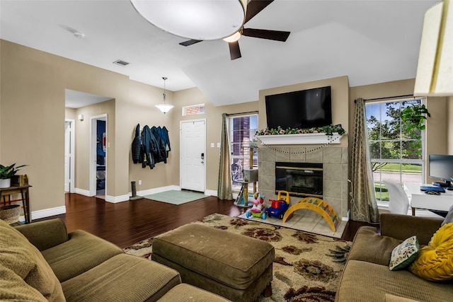 6923 Todd Ln, Sachse, TX 75048 - living area with wood finished floors, a ceiling fan, baseboards, and a tiled fireplace