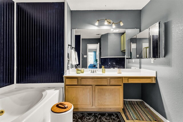 6923 Todd Ln, Sachse, TX 75048 - full bathroom featuring a bath, a textured wall, and vanity