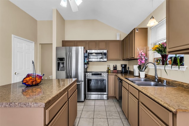 6923 Todd Ln, Sachse, TX 75048 - kitchen with appliances with stainless steel finishes, lofted ceiling, a sink, a ceiling fan, and a kitchen island