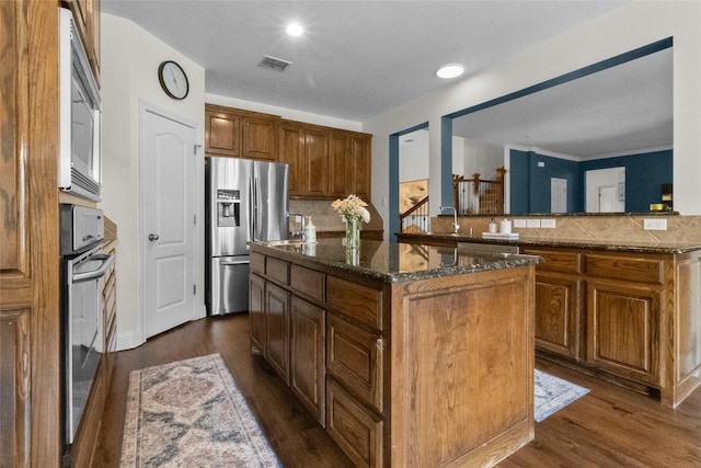 13625 Fishing Hole Ln, Fort Worth, TX 76052 - kitchen with stainless steel refrigerator with ice dispenser, oven, a center island, dark wood finished floors, and recessed lighting