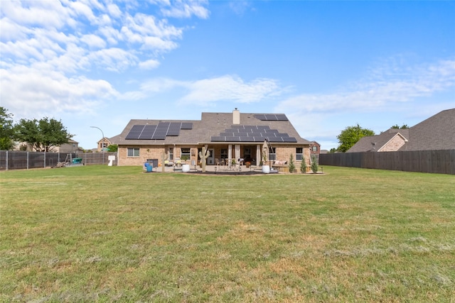 13625 Fishing Hole Ln, Fort Worth, TX 76052 - back of house featuring a patio, roof mounted solar panels, a chimney, roof with shingles, and brick siding