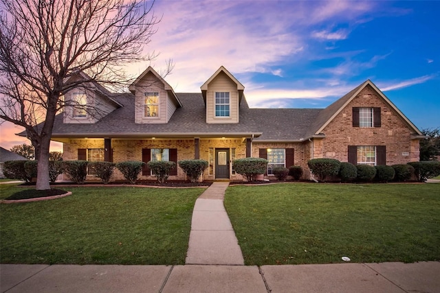 13625 Fishing Hole Ln, Fort Worth, TX 76052 - new england style home featuring a yard, brick siding, and a shingled roof