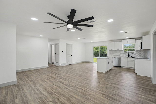 112 Gordon Dr, Azle, TX 76020 - unfurnished living room with a ceiling fan, recessed lighting, wood finished floors, a sink, and baseboards