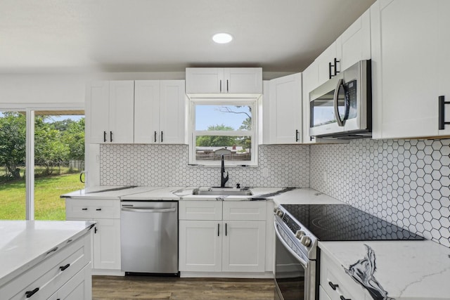 112 Gordon Dr, Azle, TX 76020 - kitchen featuring stainless steel appliances, a sink, white cabinets, and recessed lighting
