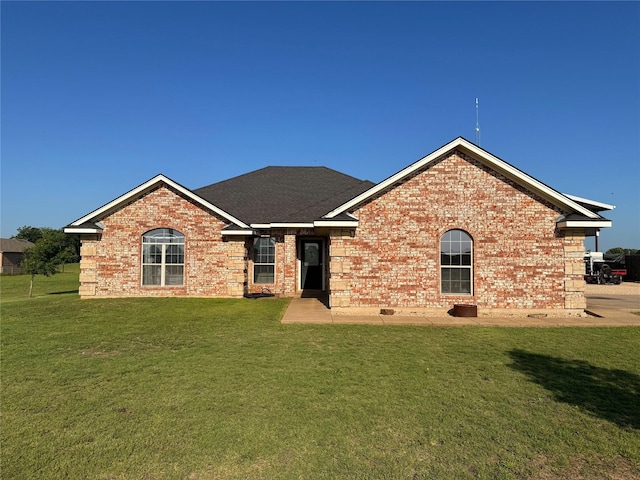 240 County Road 12550, Paris, TX 75462 - rear view of house featuring a yard, brick siding, and a shingled roof