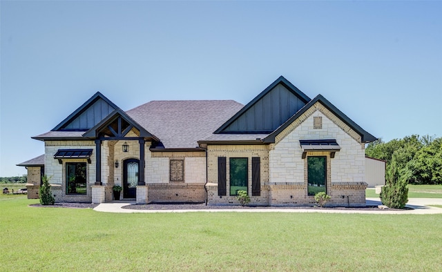 139 County Road 2525, Decatur, TX 76234 - view of front of house with board and batten siding, a front yard, stone siding, and brick siding