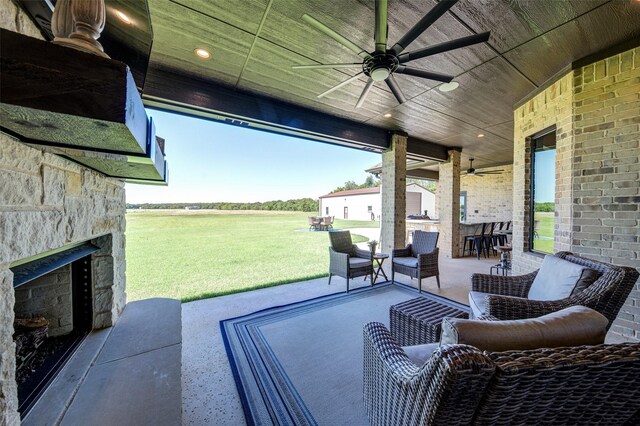 139 County Road 2525, Decatur, TX 76234 - view of patio with a ceiling fan and an outdoor stone fireplace