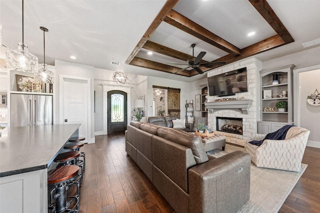139 County Road 2525, Decatur, TX 76234 - living area featuring baseboards, dark wood-style floors, a stone fireplace, ceiling fan, and beam ceiling