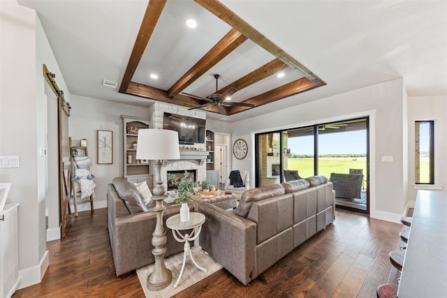 139 County Road 2525, Decatur, TX 76234 - living room with ceiling fan, a fireplace, dark wood-type flooring, baseboards, and beamed ceiling