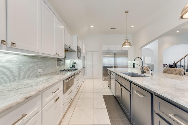 12748 Oakvale Trl, Fort Worth, TX 76244 - kitchen featuring a sink, under cabinet range hood, tasteful backsplash, built in fridge, and white cabinets