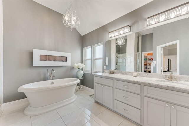 12748 Oakvale Trl, Fort Worth, TX 76244 - full bath with lofted ceiling, a chandelier, tiled shower, double vanity, and a soaking tub