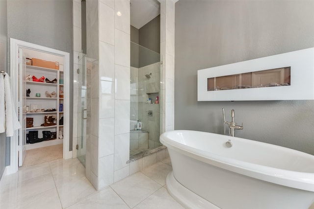 12748 Oakvale Trl, Fort Worth, TX 76244 - full bathroom featuring a spacious closet, a shower stall, a freestanding bath, and tile patterned floors