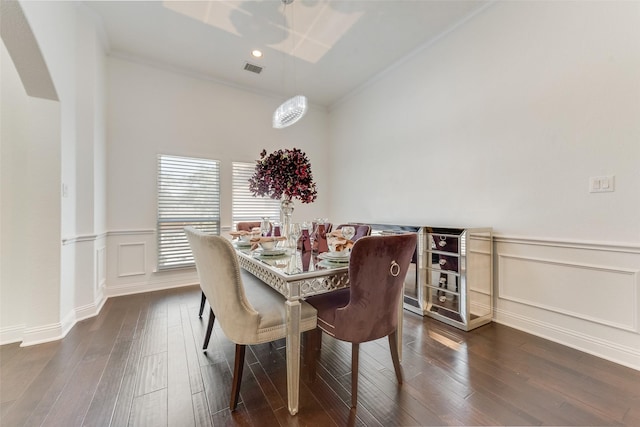 12748 Oakvale Trl, Fort Worth, TX 76244 - dining room with crown molding, dark wood finished floors, a wainscoted wall, arched walkways, and a decorative wall