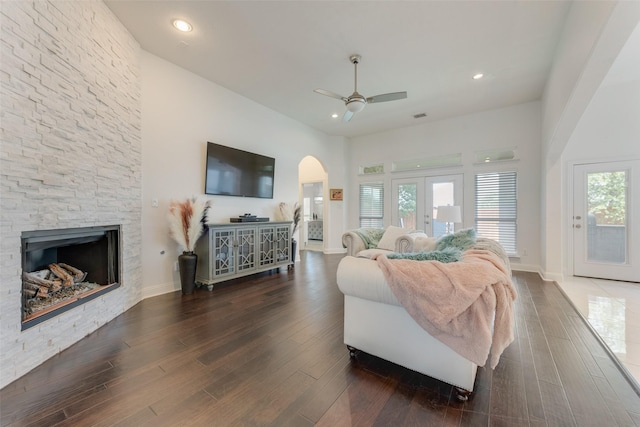 12748 Oakvale Trl, Fort Worth, TX 76244 - living area with ceiling fan, arched walkways, wood finished floors, a fireplace, and recessed lighting