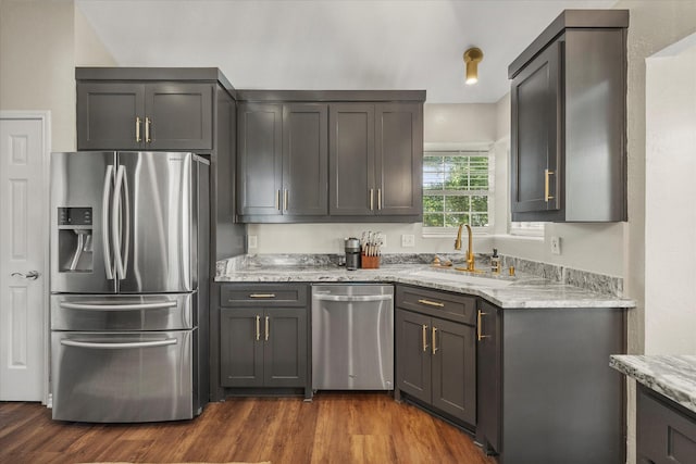509 Windsor Way, Rockwall, TX 75087 - kitchen with appliances with stainless steel finishes, a sink, light stone counters, and dark wood-style floors